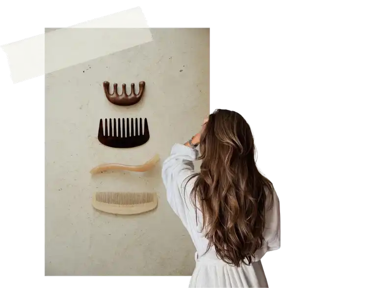 Woman viewing a display of vintage combs on a wall.