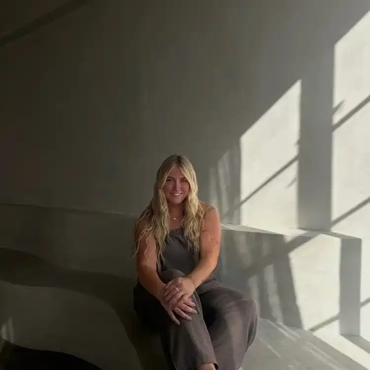 Portrait of Kylie, a professional stylist at Stranded Salon, showcasing their expertise and style.