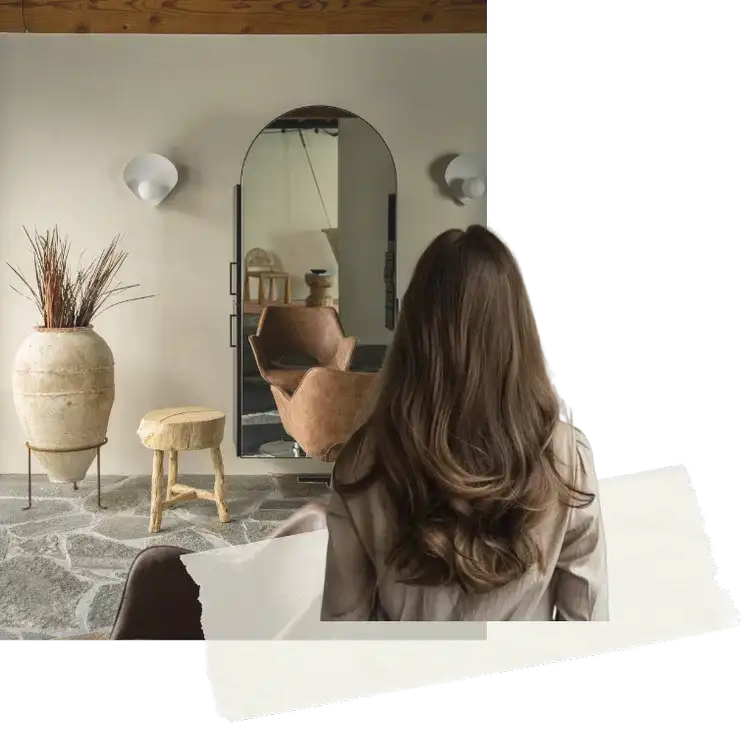 Cozy room with rustic furniture and a large mirror; woman with long hair in foreground.