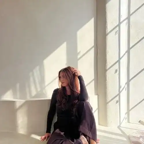 Portrait of Lindsey Gustafson, a professional stylist at Stranded Salon, showcasing their expertise and style.